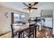 Inviting dining area with a ceiling fan and a view of the backyard through sliding windows at 8862 E Amherst Dr # D, Denver, CO 80231