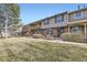 A row of townhouses showcases unique facades, bay windows, and well-maintained lawns at 8862 E Amherst Dr # D, Denver, CO 80231