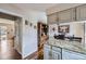 Bright kitchen with light-colored cabinetry and a breakfast bar overlooking the dining area with wood floors at 8862 E Amherst Dr # D, Denver, CO 80231