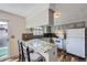 Well-lit kitchen with granite countertops and modern appliances, adjacent to dining area at 8862 E Amherst Dr # D, Denver, CO 80231