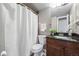 Bathroom features a modern vanity with granite counters and shower with curtain at 3047 W 47Th Ave # 112, Denver, CO 80211