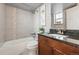 Bathroom features a modern vanity with granite counters and tiled shower over tub at 3047 W 47Th Ave # 112, Denver, CO 80211