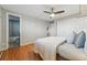 Bedroom featuring hardwood floors, a ceiling fan, ensuite bathroom, and double door closet at 3047 W 47Th Ave # 112, Denver, CO 80211