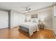 Bright bedroom features hardwood floors, a ceiling fan, and a double door closet at 3047 W 47Th Ave # 112, Denver, CO 80211