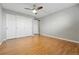 Bedroom featuring hardwood floors, a ceiling fan, and a double door closet at 3047 W 47Th Ave # 112, Denver, CO 80211