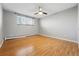 Empty bedroom featuring hardwood floors, a ceiling fan, and a large window at 3047 W 47Th Ave # 112, Denver, CO 80211