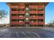 Brick apartment building with multiple red balconies offering outdoor living space and curb appeal at 3047 W 47Th Ave # 112, Denver, CO 80211