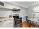 Modern kitchen with a stainless steel oven and a cozy table near the kitchen that provides an inviting and practical cooking space at 3047 W 47Th Ave # 112, Denver, CO 80211