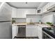 Well-equipped kitchen with white cabinets and stainless steel appliances offering a functional and appealing cooking space at 3047 W 47Th Ave # 112, Denver, CO 80211