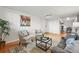 Bright living room with hardwood floors, stylish furnishings, and a seamless flow to the dining area, creating a welcoming space at 3047 W 47Th Ave # 112, Denver, CO 80211