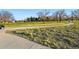 Scenic view of a paved pathway leading through a lush green park at 3047 W 47Th Ave # 112, Denver, CO 80211