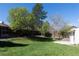 Spacious backyard with lush green grass and privacy fence, perfect for recreation at 7328 S Kit Carson St, Centennial, CO 80122