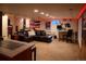 Finished basement featuring a comfortable leather sectional sofa and a workstation at 7328 S Kit Carson St, Centennial, CO 80122