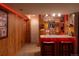Basement bar area offering an inviting space for entertainment with custom lighting at 7328 S Kit Carson St, Centennial, CO 80122