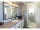 Bathroom features large mirror, bright lighting, and stylish fixtures at 7328 S Kit Carson St, Centennial, CO 80122