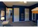 Blue bedroom with hanging bed, overhead fan, double closets, and natural lighting at 7328 S Kit Carson St, Centennial, CO 80122