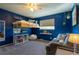 Stylish blue bedroom featuring a unique loft bed and comfortable seating area at 7328 S Kit Carson St, Centennial, CO 80122