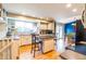 Bright kitchen featuring an island with seating, a large sink, and modern appliances at 7328 S Kit Carson St, Centennial, CO 80122