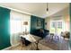 Cozy living room with French doors, a blue couch and neutral armchairs at 7328 S Kit Carson St, Centennial, CO 80122