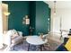 Inviting living room with comfortable seating and stylish decor on green walls at 7328 S Kit Carson St, Centennial, CO 80122