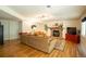 Basement living room with a brick fireplace, plush sofa, and ample seating at 7328 S Kit Carson St, Centennial, CO 80122