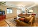 Spacious basement living area with hardwood floors, comfortable seating, and natural light at 7328 S Kit Carson St, Centennial, CO 80122