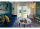 Charming living area with ample seating, marble table, and a view to backyard at 7328 S Kit Carson St, Centennial, CO 80122