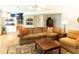 Cozy basement living area featuring a comfortable sofa, coffee table, and hardwood floors at 7328 S Kit Carson St, Centennial, CO 80122