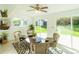 Bright sunroom with wicker furniture and views of the backyard at 7328 S Kit Carson St, Centennial, CO 80122