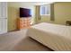 Comfortable bedroom featuring a dresser and a window allowing natural light at 17505 E Mansfield Ave # 1411L, Aurora, CO 80013
