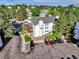 Exterior aerial view shows the building, mature trees, landscaping, and a parking area at 17505 E Mansfield Ave # 1411L, Aurora, CO 80013