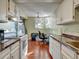 Functional kitchen offering white appliances, dark countertops, and access to an outdoor balcony at 17505 E Mansfield Ave # 1411L, Aurora, CO 80013