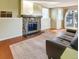 Inviting living room with a stone fireplace and sliding doors to the outside at 17505 E Mansfield Ave # 1411L, Aurora, CO 80013