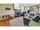 Cozy living room with a stone fireplace, wooden floors, and sliding door access to the outside at 17505 E Mansfield Ave # 1411L, Aurora, CO 80013