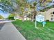 A view of the Victoria Crossing sign shows the surrounding green grass at 17505 E Mansfield Ave # 1411L, Aurora, CO 80013