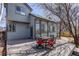 Charming backyard with a deck, dining table, and a lush garden, perfect for outdoor gatherings at 6527 Torrey Ct, Arvada, CO 80007