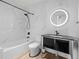Modern bathroom with marble tiling, stylish vanity, and a bathtub with shower at 891 14Th St # 2314, Denver, CO 80202