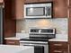 Modern kitchen with stainless steel appliances, mosaic backsplash and white countertops at 891 14Th St # 2314, Denver, CO 80202