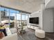 Bright living room with floor-to-ceiling windows offering expansive city views and stylish modern decor at 891 14Th St # 2314, Denver, CO 80202