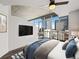Serene bedroom with concrete ceilings, city views, and a comfortable bed for relaxation at 891 14Th St # 2314, Denver, CO 80202