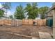 Spacious backyard with a greenhouse, shed and wood fence at 113 S 4Th Ave, Brighton, CO 80601