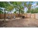 Fenced backyard with room for entertaining with seating, plants, wheelbarrow and open space for activities at 113 S 4Th Ave, Brighton, CO 80601