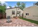 An inviting backyard with flagstone patio, artificial grass and a stone fire pit at 113 S 4Th Ave, Brighton, CO 80601