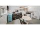 Basement kitchenette featuring vintage-style appliances, floating shelves, and a dining area at 113 S 4Th Ave, Brighton, CO 80601