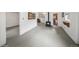 Finished basement area with wood-burning stove, painted floors and a storage area at 113 S 4Th Ave, Brighton, CO 80601