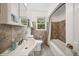 Cozy bathroom with a neutral color scheme, built in mirror, and tiled shower at 113 S 4Th Ave, Brighton, CO 80601
