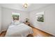 Cozy bedroom with hardwood floors, natural light, and neutral decor at 113 S 4Th Ave, Brighton, CO 80601