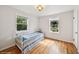 Bright bedroom with hardwood floors and plenty of natural light from two windows at 113 S 4Th Ave, Brighton, CO 80601