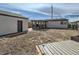 View of a spacious backyard with a detached garage and covered patio, offering outdoor living potential at 5050 Steele St, Denver, CO 80216