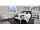 Bright bedroom with a cozy chair, large windows, and a comfortable bed with neutral accents at 5050 Steele St, Denver, CO 80216